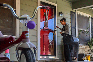 A CCL inspector knocking on the doors of a home day care