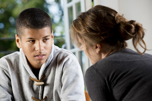 A young adult speaking to an investigator