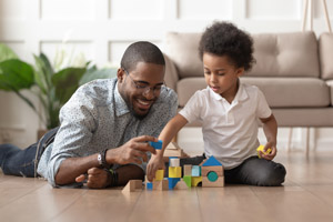 a father and son play with blocks